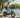 Active rider enjoying a low-impact cardio fitness ride on a Wildeway FW11S 3.0 step-thru e-bike in a sunny park.