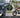 Split image showing a stressed driver stuck in urban traffic versus a smiling commuter riding a Wildeway e-bike along a sunny bike path.