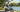 Active rider enjoying a low-impact cardio fitness ride on a Wildeway FW11S 3.0 step-thru e-bike in a sunny park.
