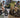 Split comparison banner illustrating 750W Class 2 street-legal mode on public roads versus 2000W AWD dual-motor mode on off-road mountain trails.