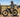 Rancher riding a Soared high-step dual-motor e-bike while inspecting a fence line on a sunny Montana ranch.